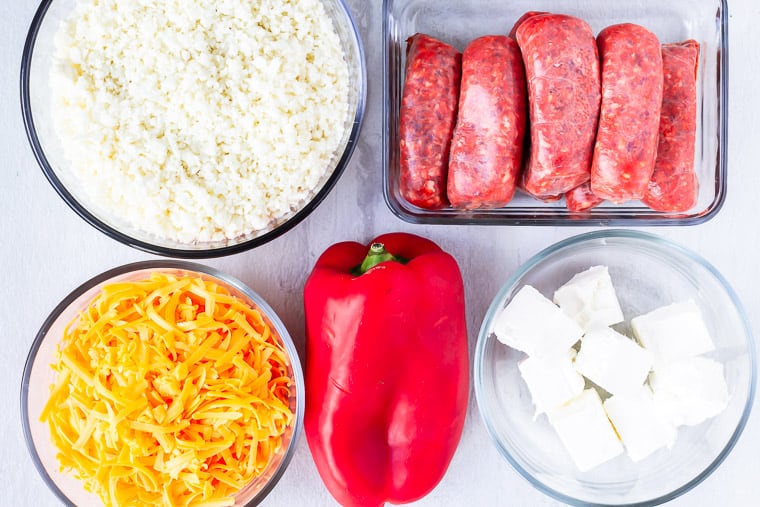 Ingredients needed for hot italian sausage casserole on a white background