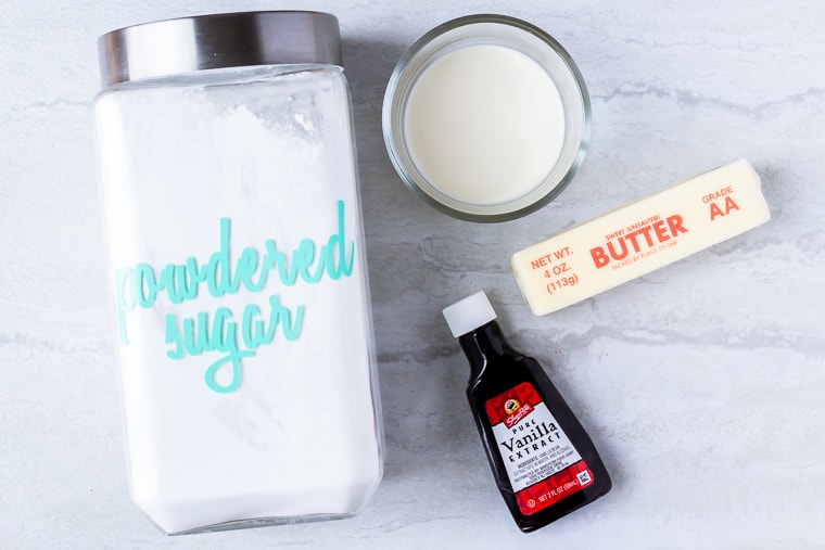 Ingredients needed to make vanilla buttercream frosting on a white background