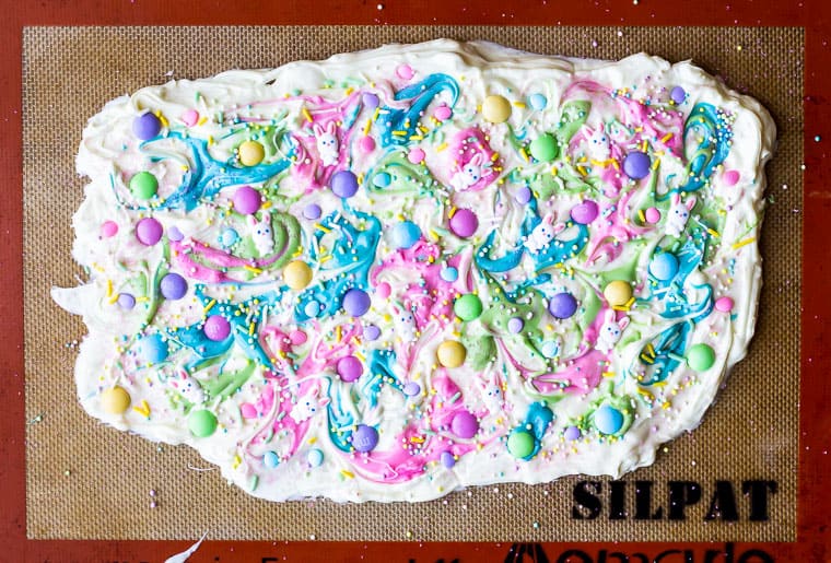 Melted white chocolate spread onto a silpat mat and topped with m&m's, bunny candies and sprinkles