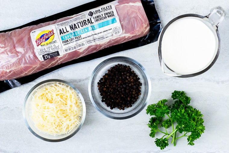 Ingredients needed to make pork with parmesan peppercorn sauce on a white background