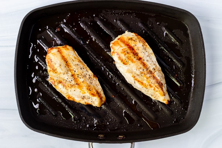 2 grilled chicken breasts in a grill pan