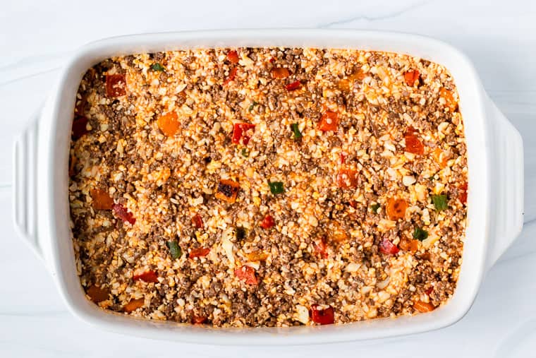 Ground beef, cauliflower rice, and peppers in a large casserole dish