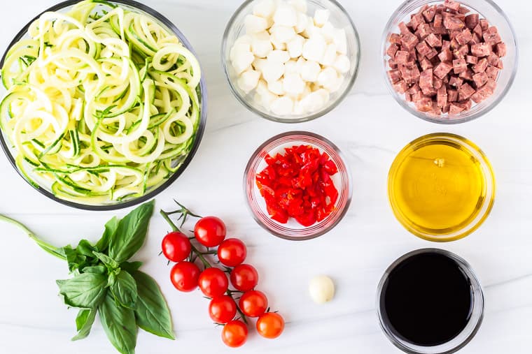 Ingredients for zucchini salad on a white background