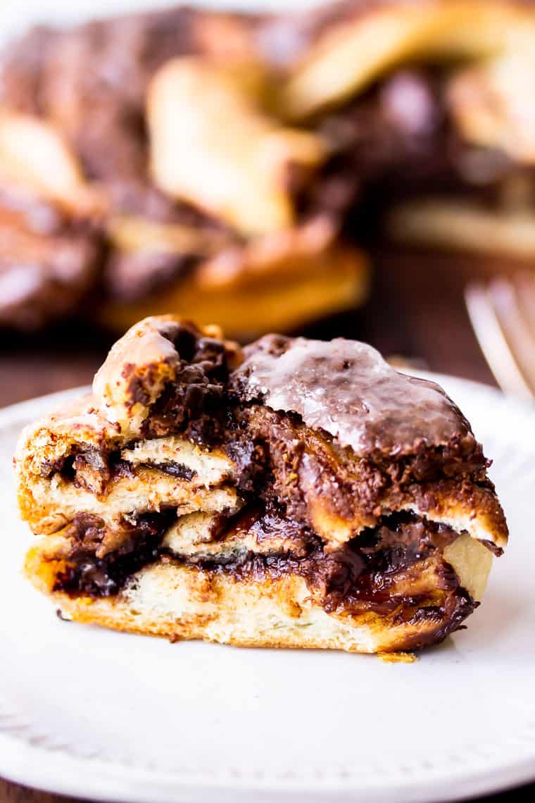 Close up of a slice of Nutella Babka with the rest of the babka blurred in the background