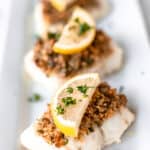 Baked Cod with Panko topped with lemon with text overlay.