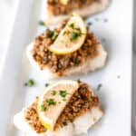 Baked Cod with Panko topped with lemon with text overlay.