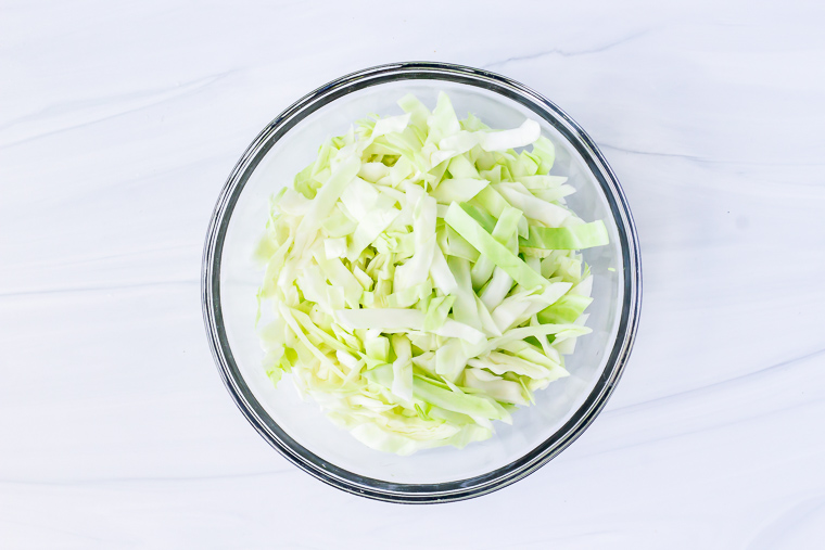 Cabbage in a glass bowl on a white background