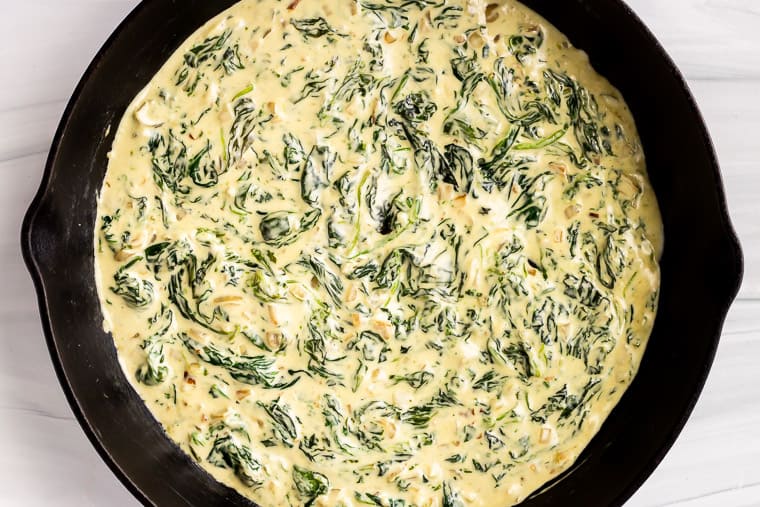 Cheesy Keto Creamed Spinach in a black cast iron pan