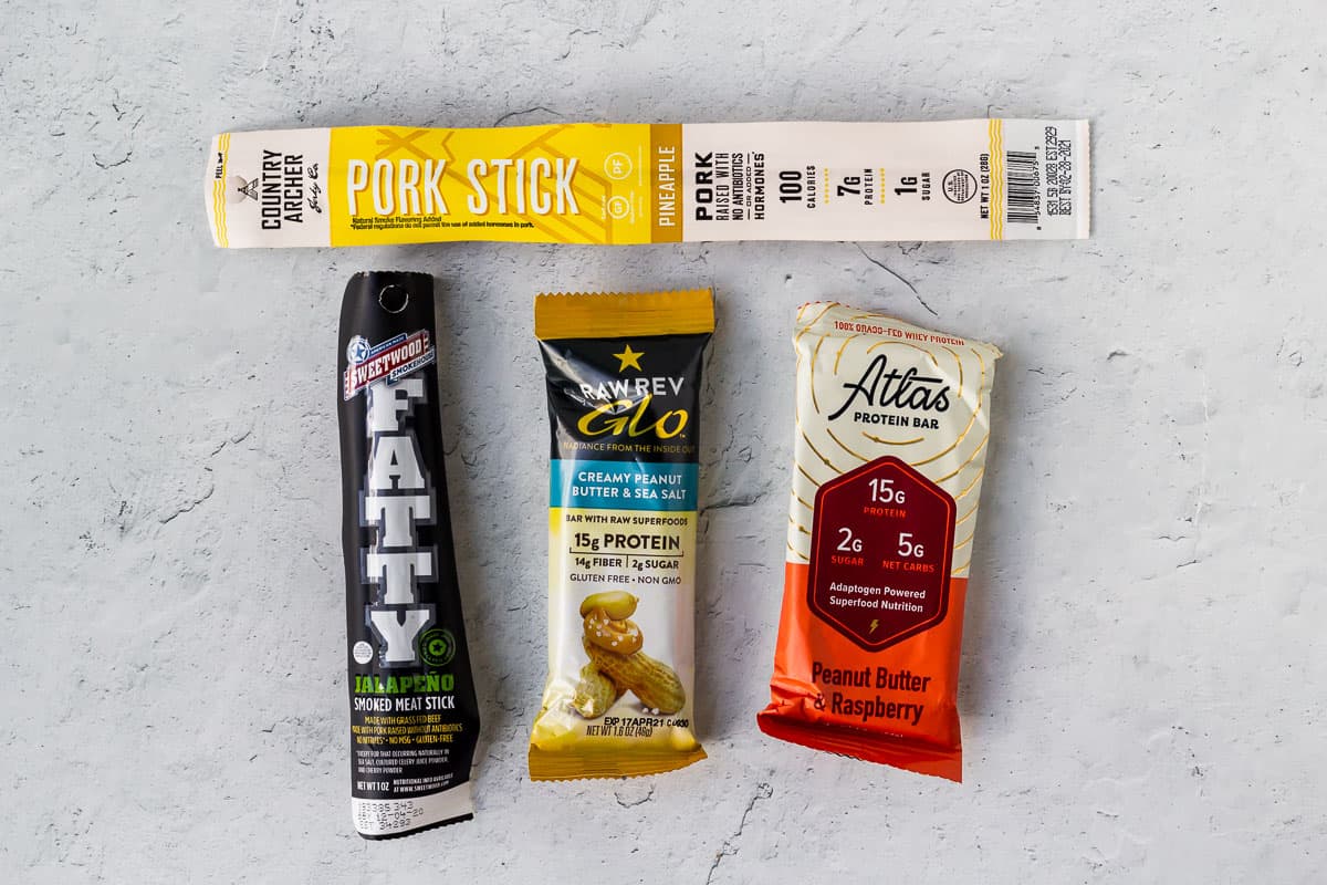 2 keto bars and 2 meat sticks on a white background
