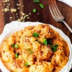 Chipotle Cheddar Cauliflower Mac and Cheese in a bowl on a wood background
