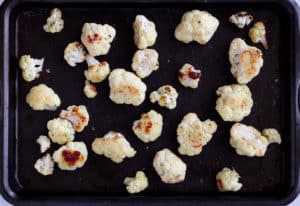 Roasted cauliflower florets on a baking sheet