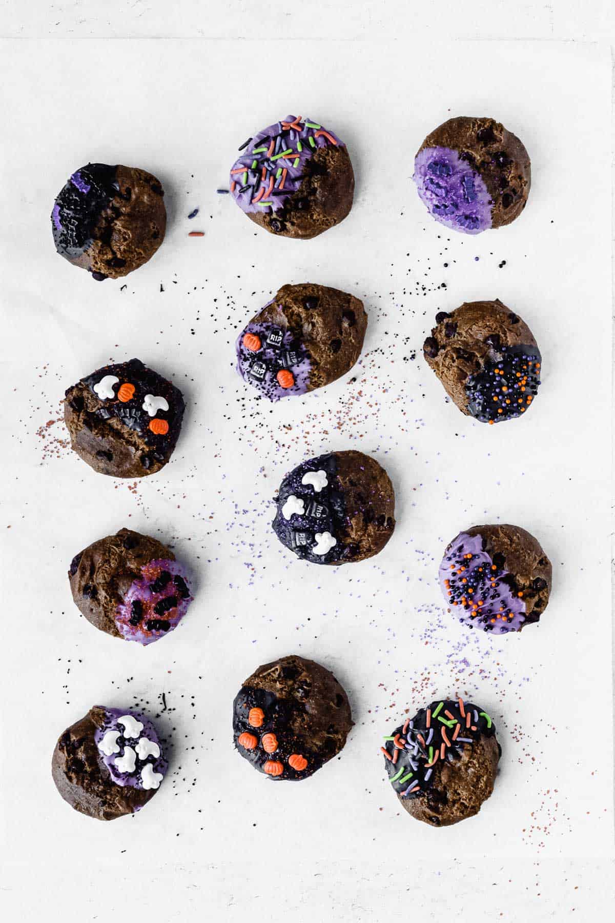 Chocolate chip cookies decorated for Halloween on a sheet of parchment paper