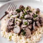 Beef stroganoff on a white plate with text overlay