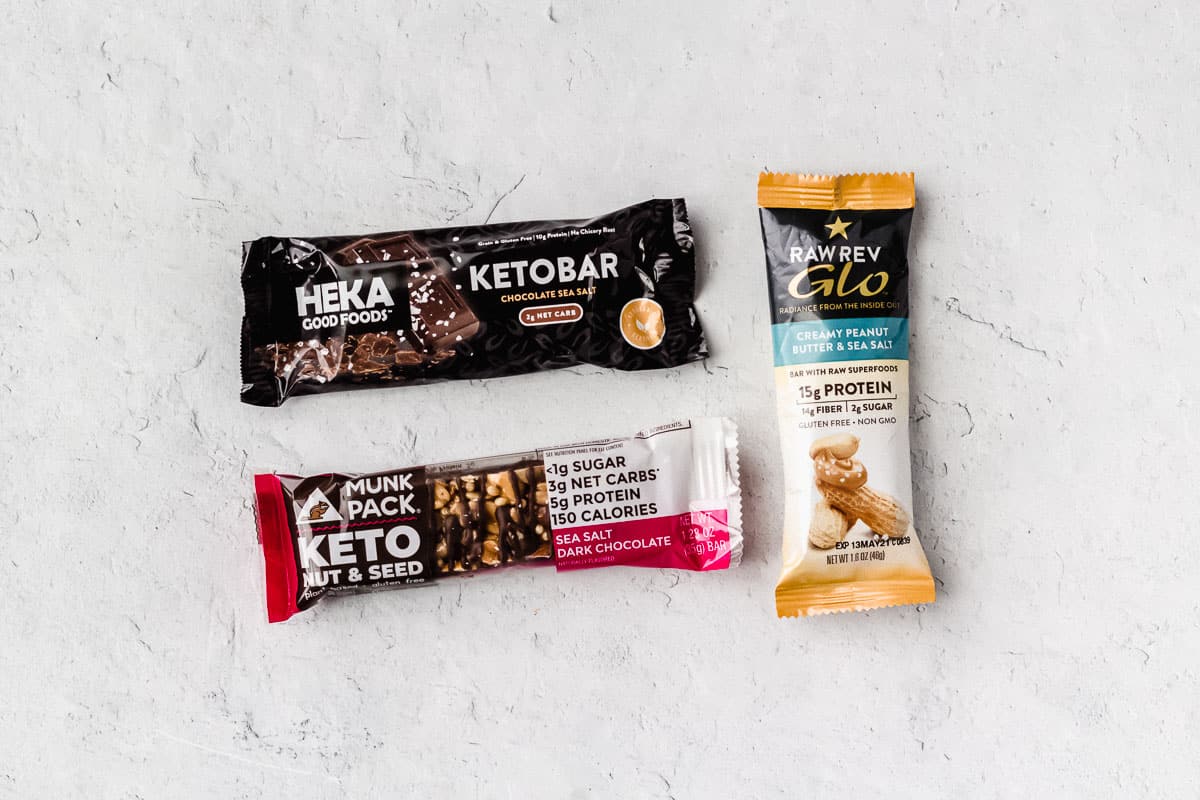 3 different keto bars on a white background