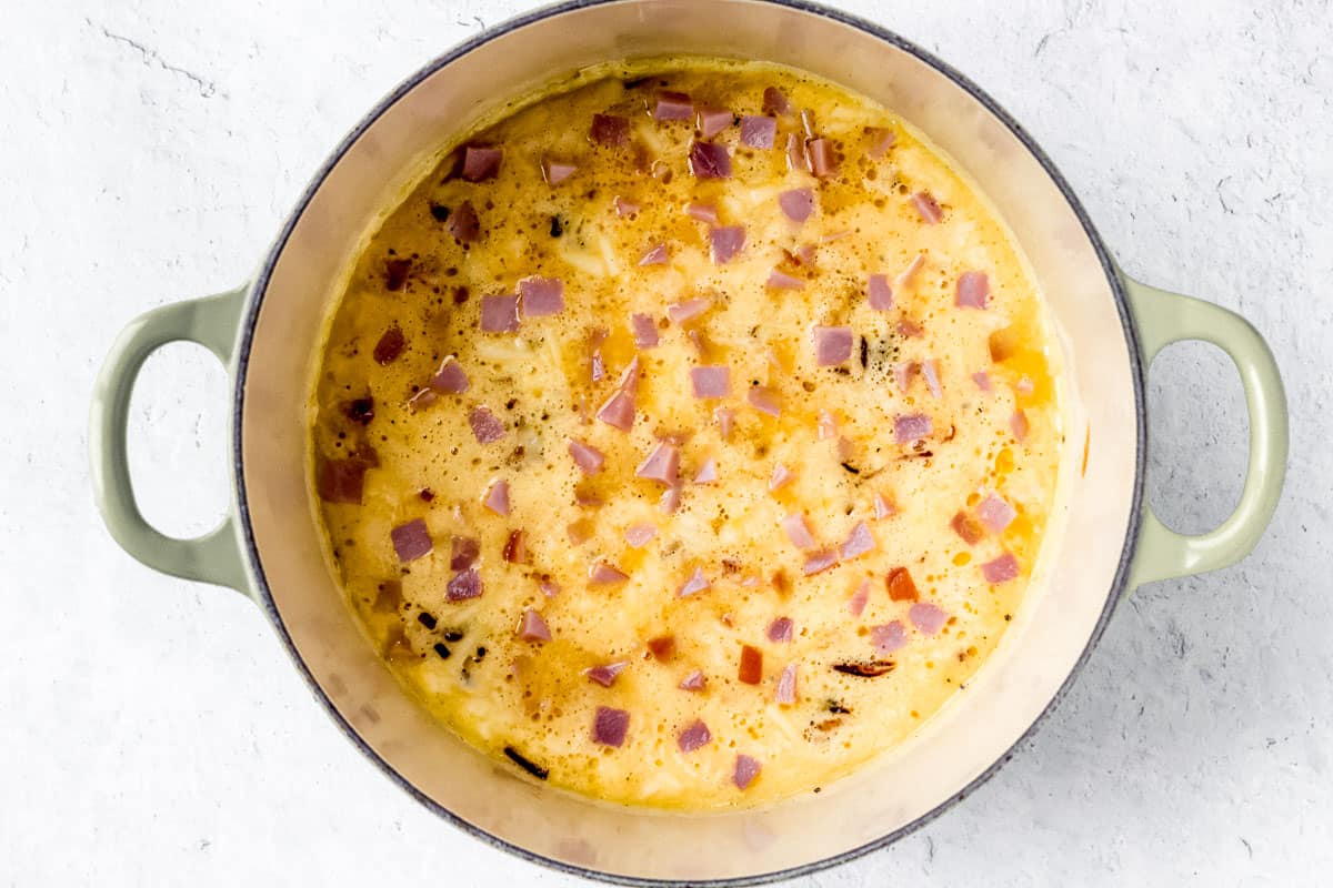Diced ham on top of a frittata before baking