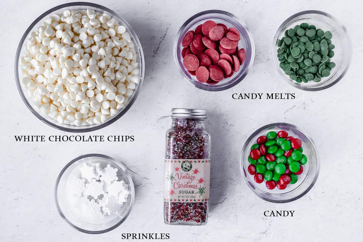 Ingredients to make christmas bark on a white background with labels