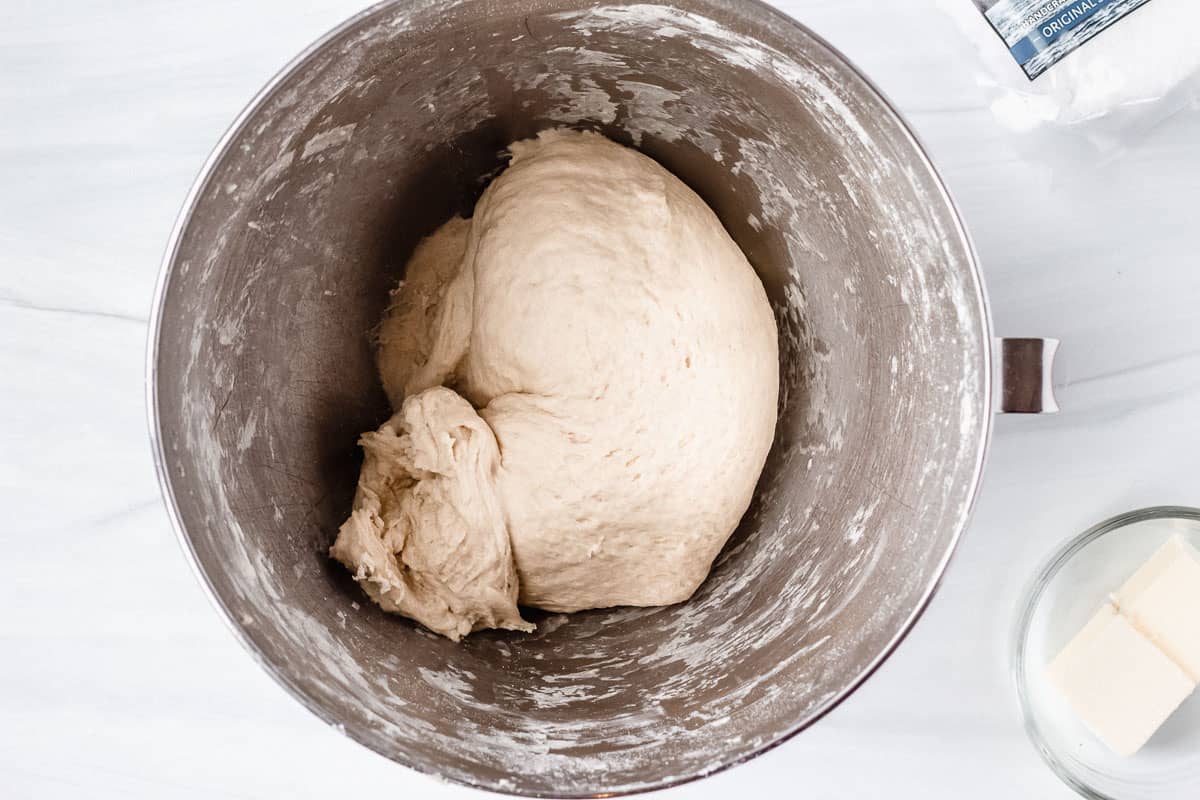 Pretzel dough in a silver mixing bowl