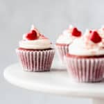 Mini Red Velvet Cupcakes on a white cake stand with a gray background