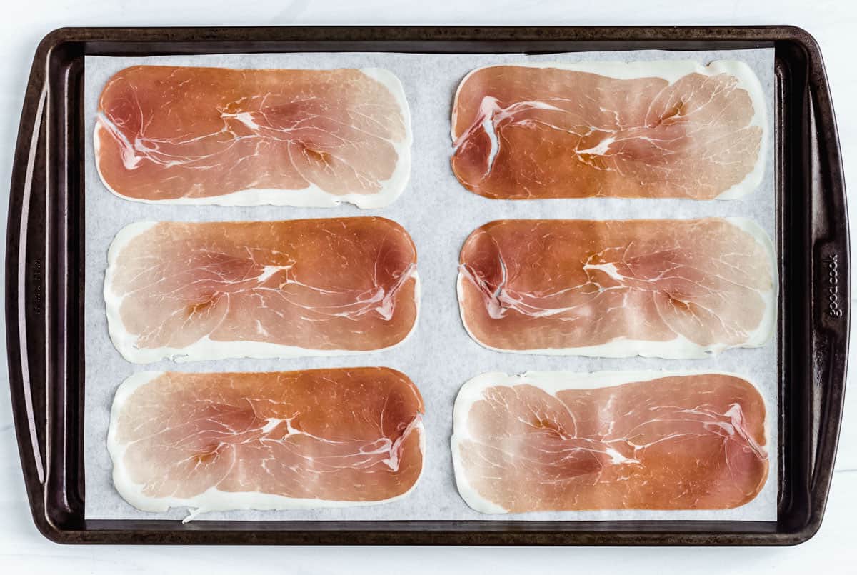 6 slices of prosciutto on a parchment paper lined baking sheet