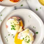 Overhead of keto eggs Benedict on a white plate with text overlay.