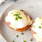 Keto eggs Benedict on a white plate with text overlay.