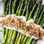 Broiled asparagus with cheese sauce with text overlay