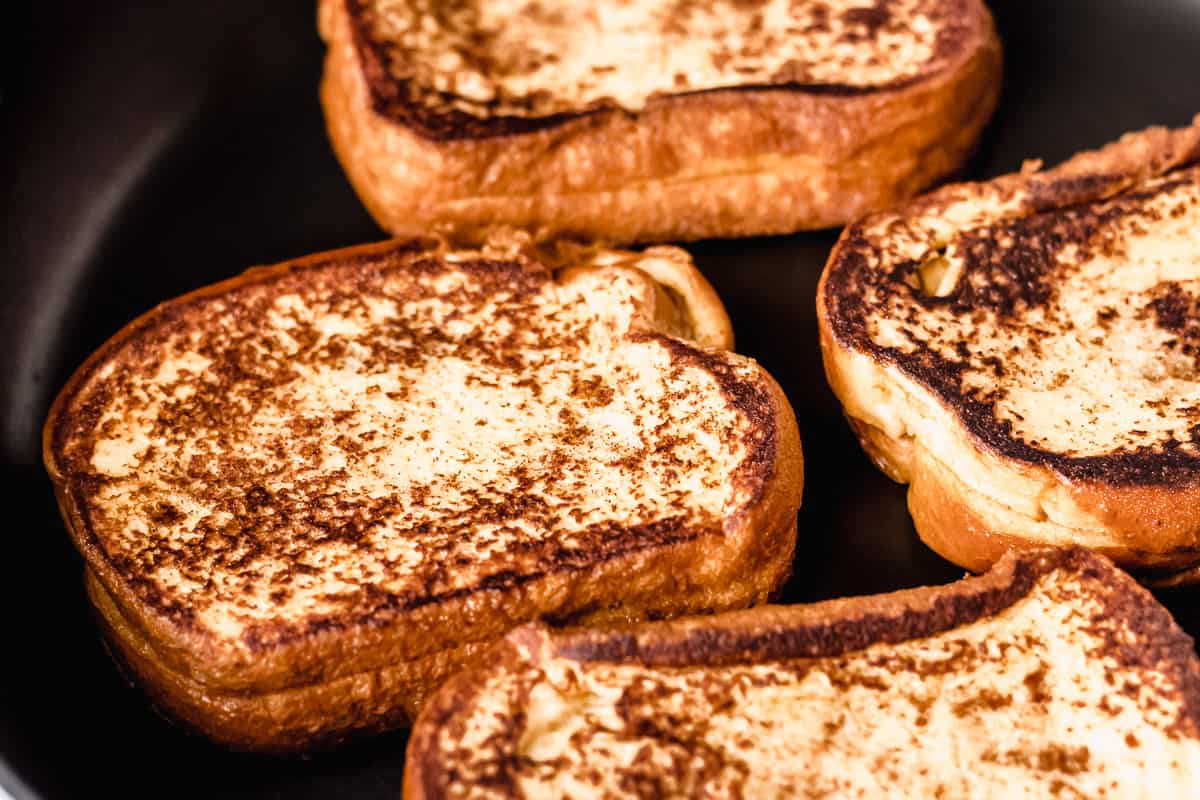 Close up of grilled french toast in a black skillet