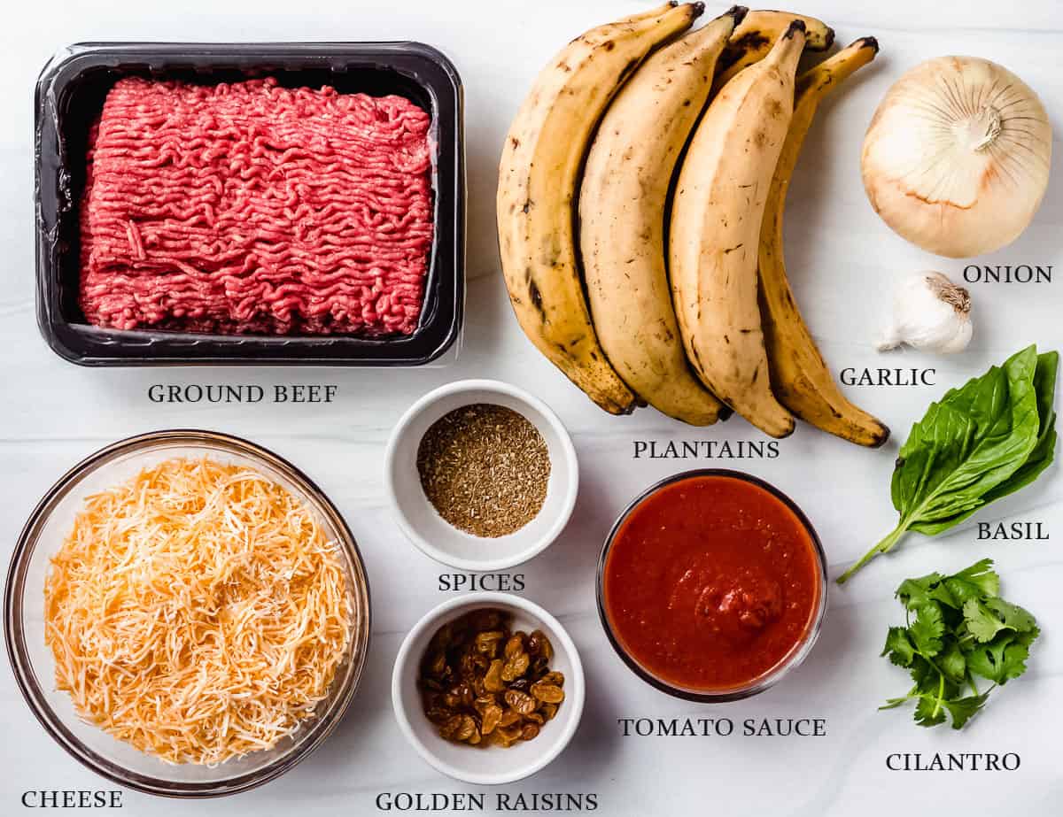 Ingredients to make sweet plantain lasagna on a white background with labels