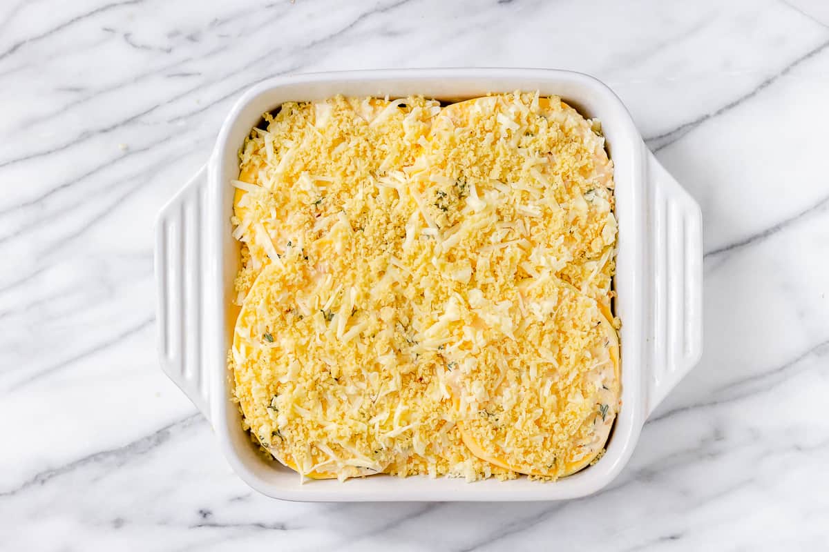 Rutabaga gratin before baking in a white, square baking dish