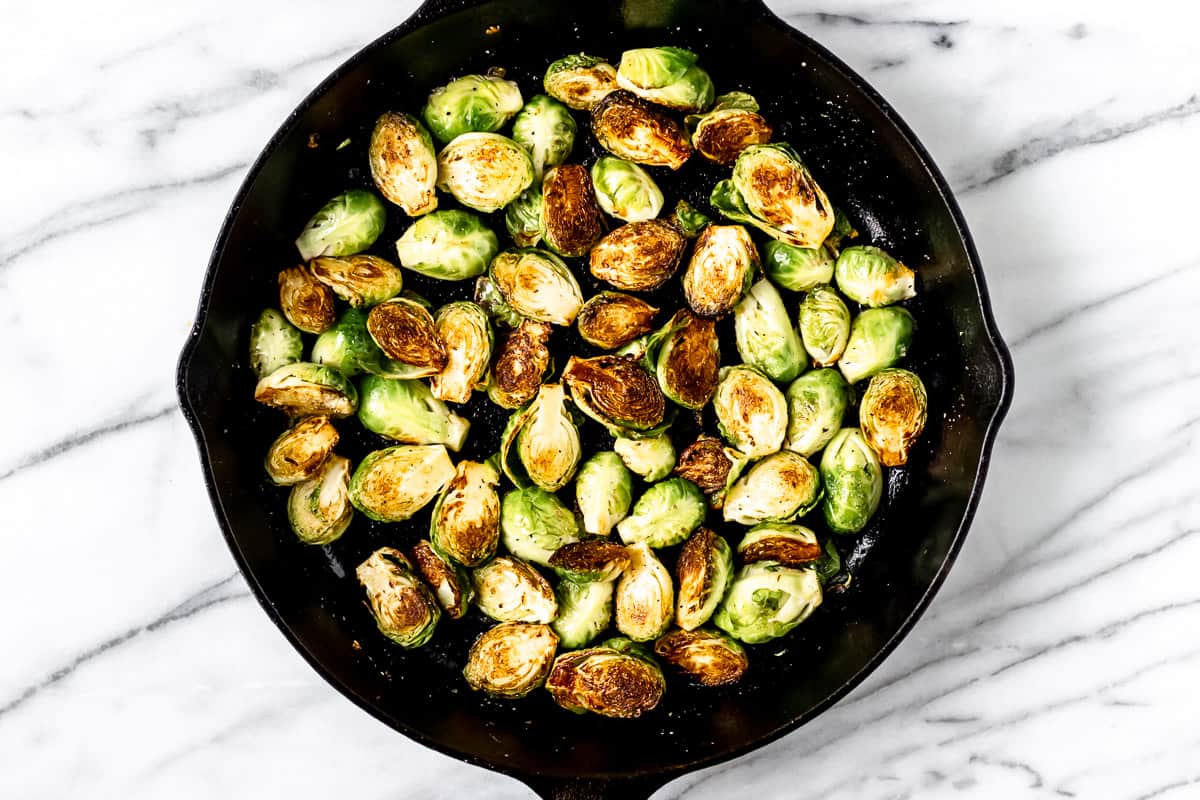 pan sautéed brussels sprouts in a cast iron skillet
