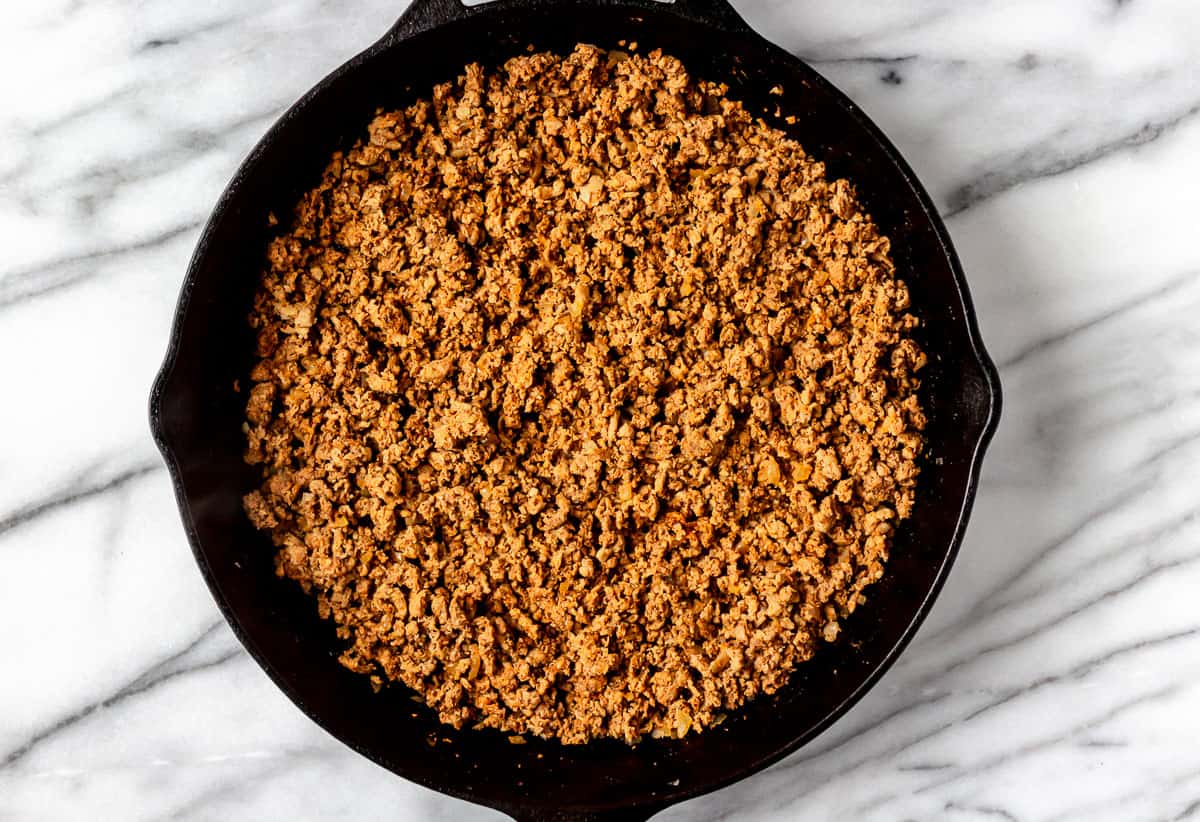 Seasoned ground turkey in a cast iron skillet