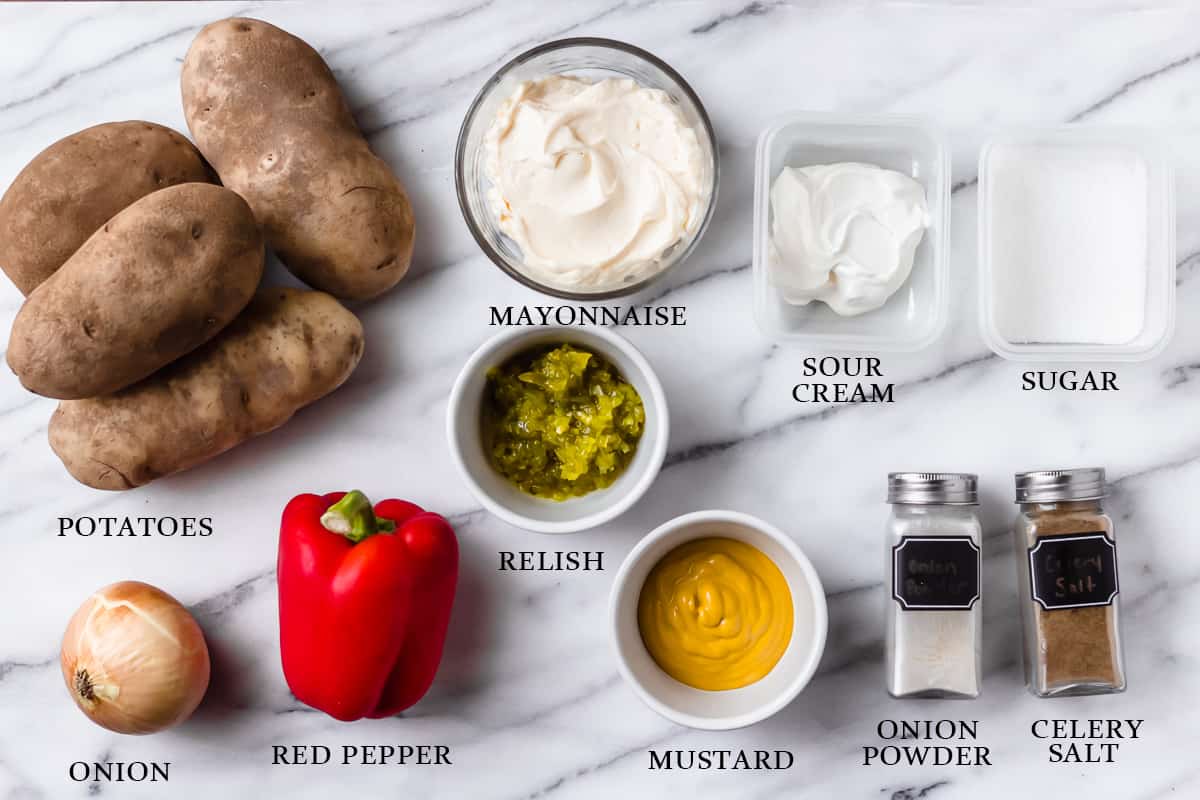 Ingredients needed to make Amish Potato Salad on a marble background with labels