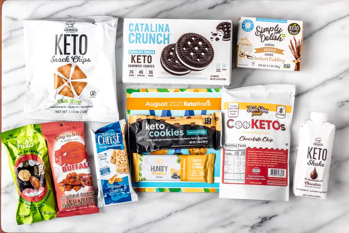 All of the items in the August 2021 Keto Krate laid out on a marble background