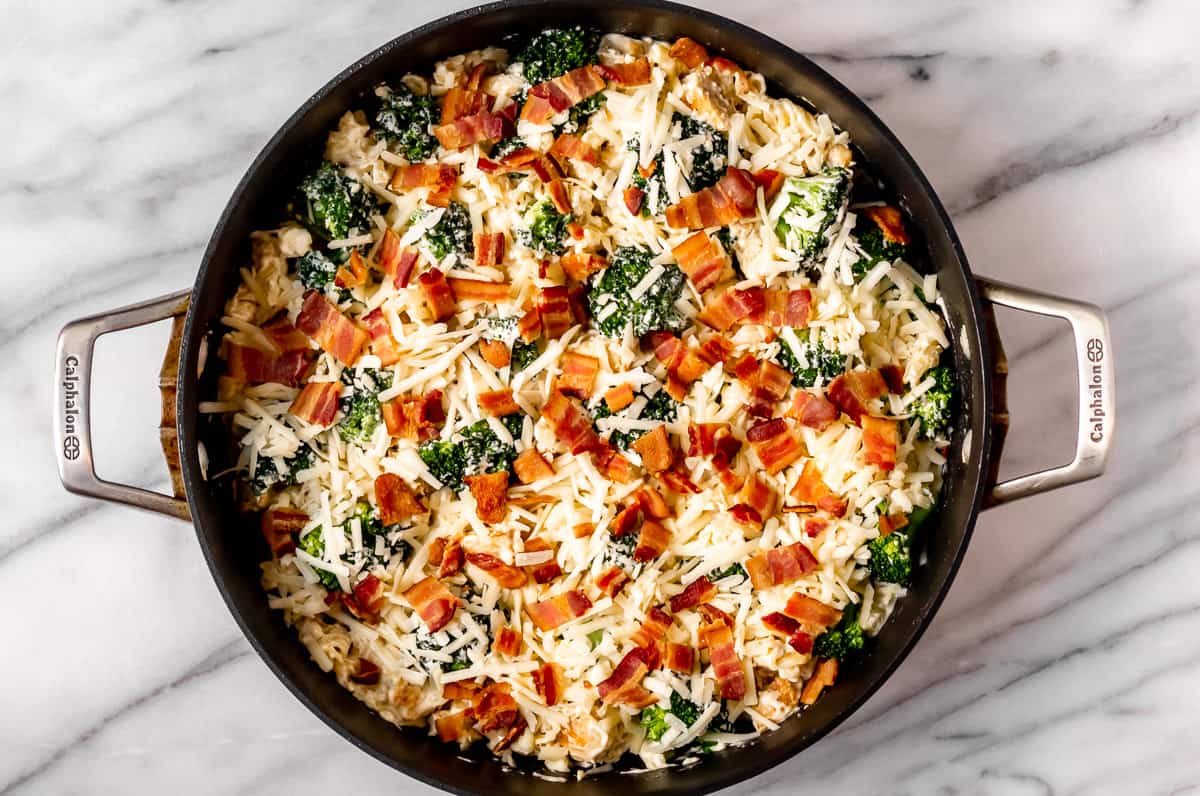 Chicken bacon ranch pasta with cheese and bacon on top in a skillet