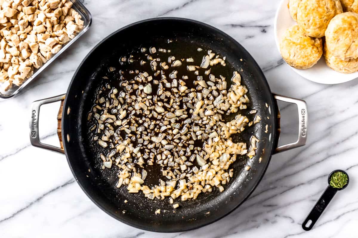 Onions cooking in a black skillet