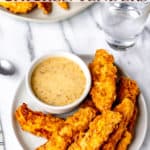 Overhead of a plate of chicken tenders and dipping sauce with text overlay.