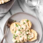 Creamed chicken over biscuits with text overlay.