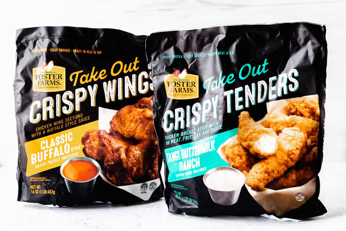 2 packages of Foster Farms Take Out Chicken Wings and Tenders with a white background.