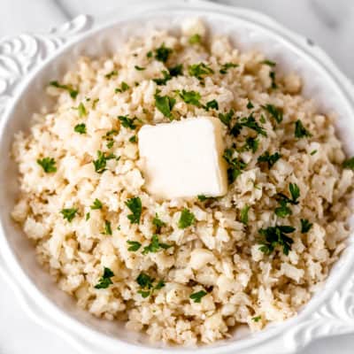 Close up of garlic cauliflower rice in a white bowl