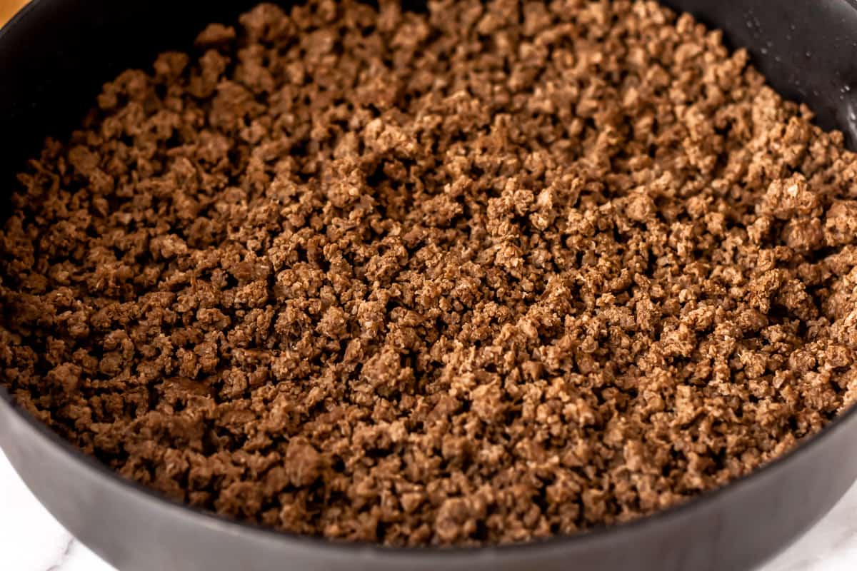 Cooked ground beef in a skillet close up.