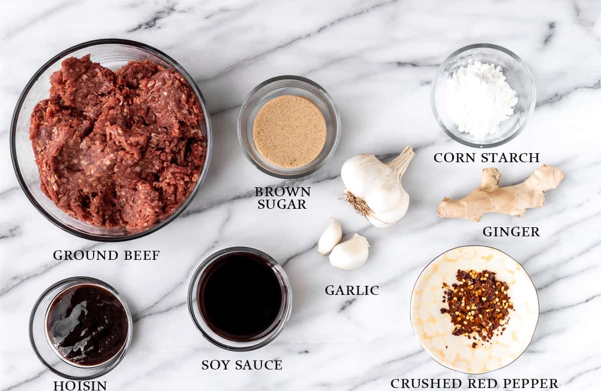 Ingredients to make Mongolian ground beef on a marble background with text overlay.