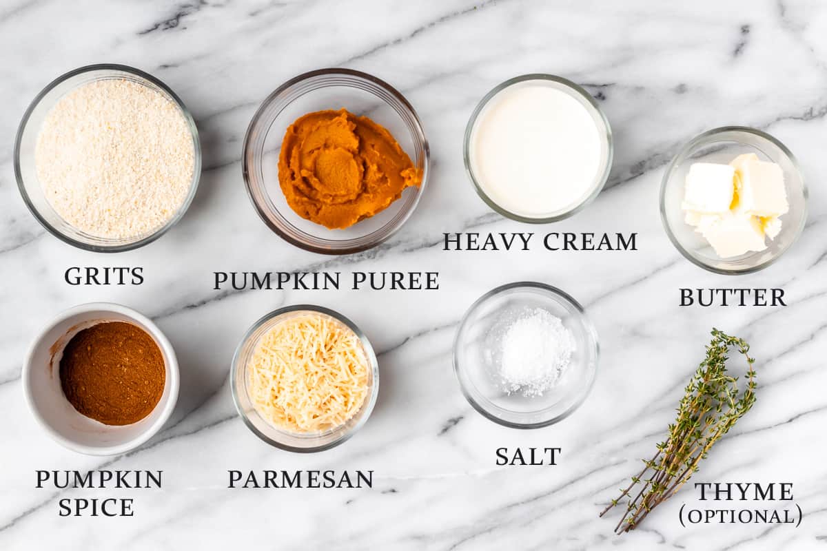 Ingredients needed to make pumpkin grits on a marble background with text overlay.