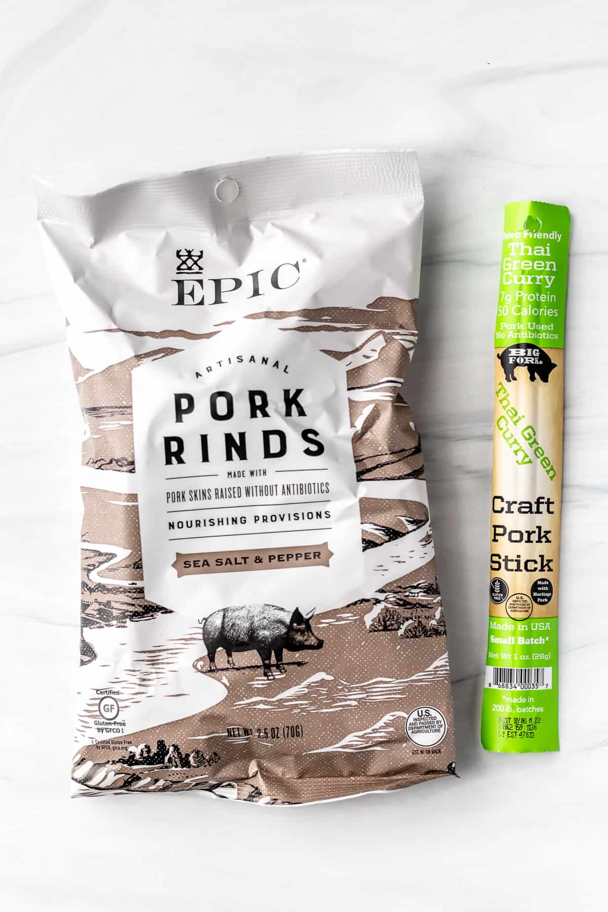 Pork rinds and a pork stick on a white background
