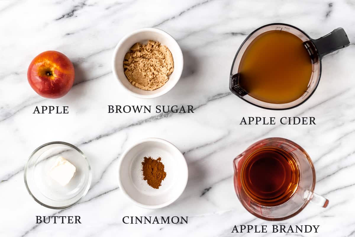 Ingredients needed to make an apple brandy cider with text overlay.
