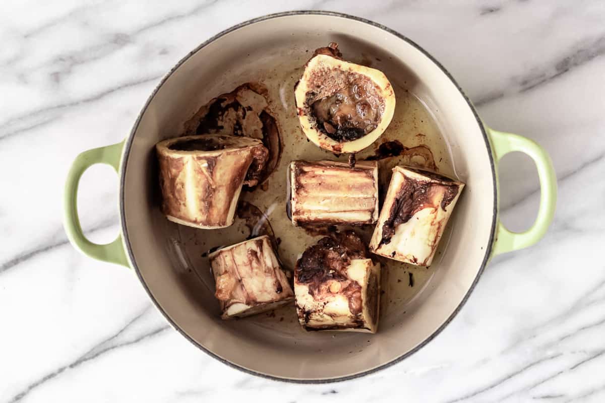 Roasted beef bones in a Dutch oven.