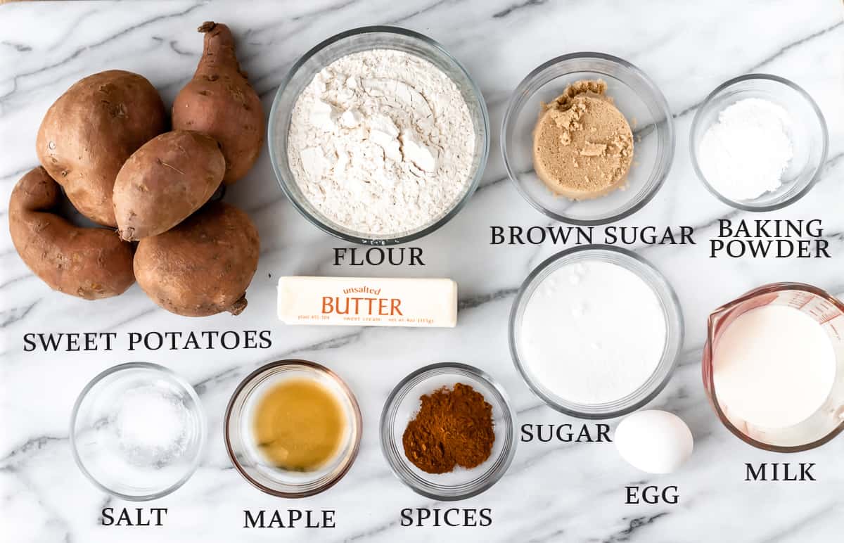 Ingredients needed to make a sweet potato cobbler on a marble background with text overlay.