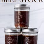 Jars of homemade beef stock with text overlay.