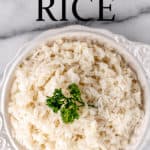 Overhead view of garlic rice in a bowl with text overlay.