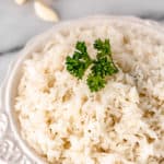 Garlic rice in a bowl with text overlay.
