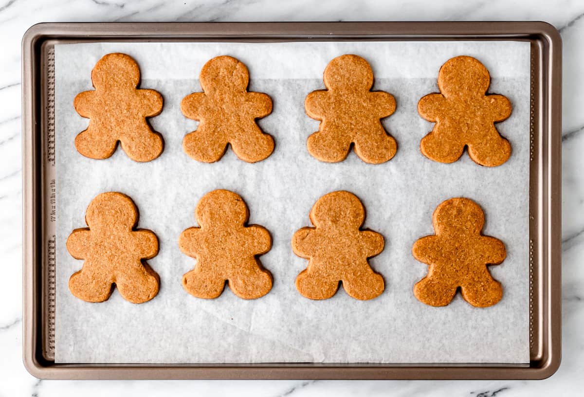 8 baked gingerbread cookies on a baking sheet.